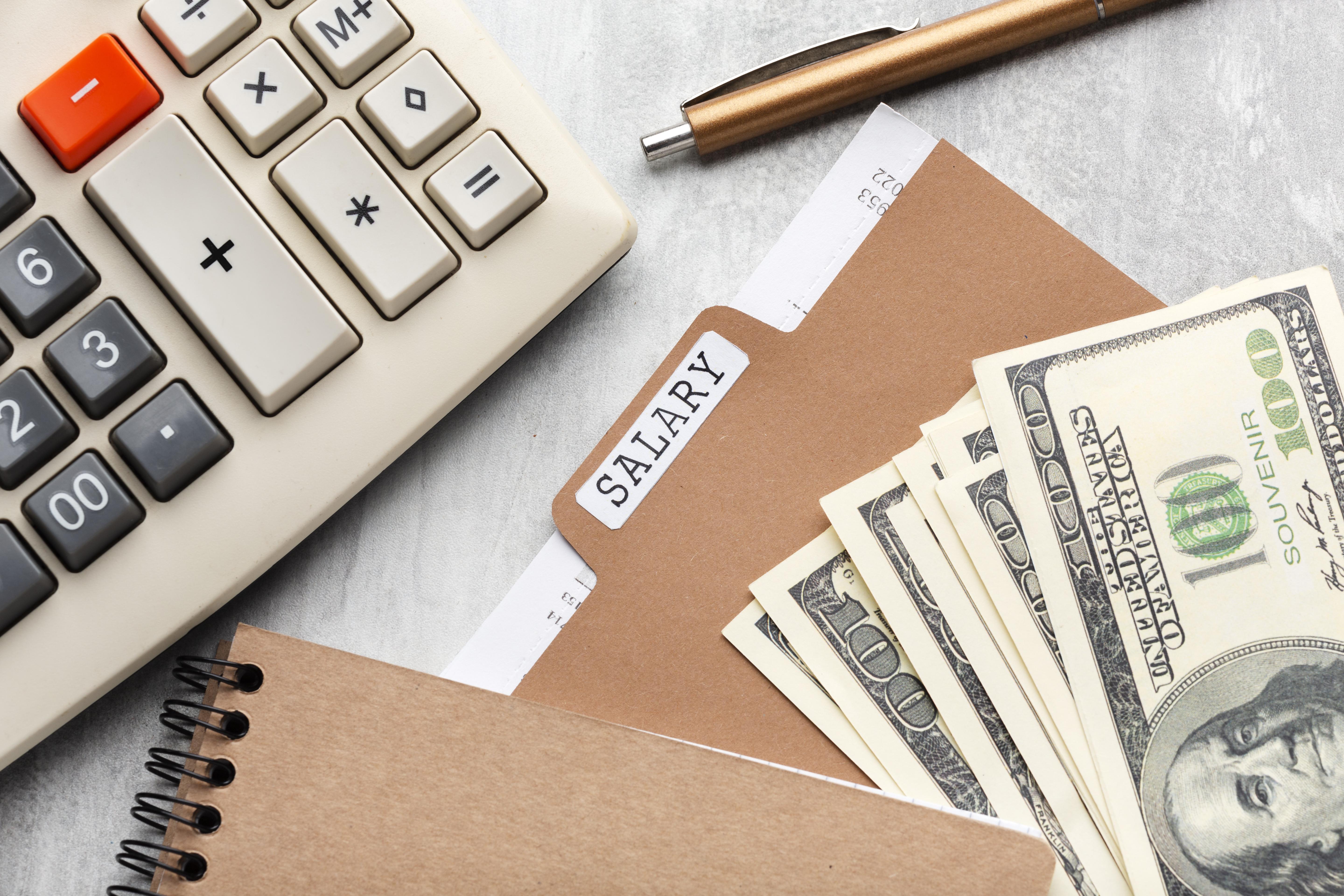 top-view-payroll-concept-with-cash